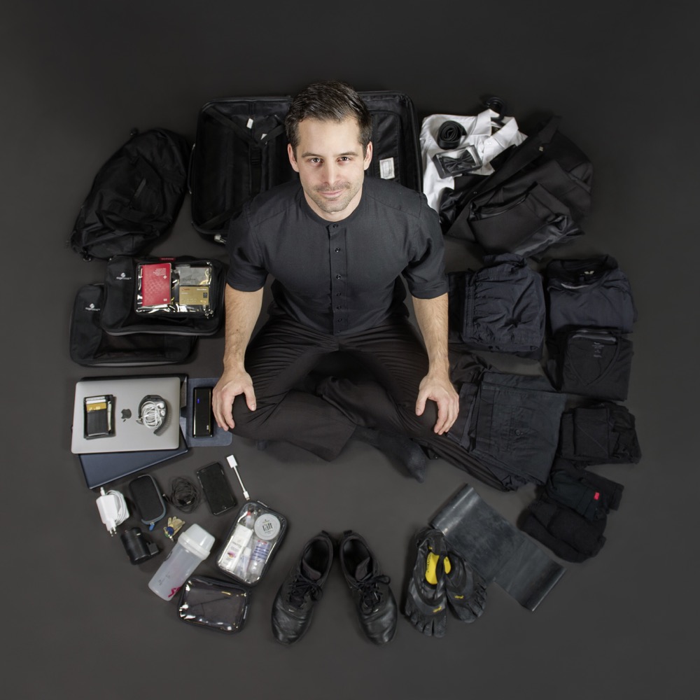 Overhead, sitting among all his belongings