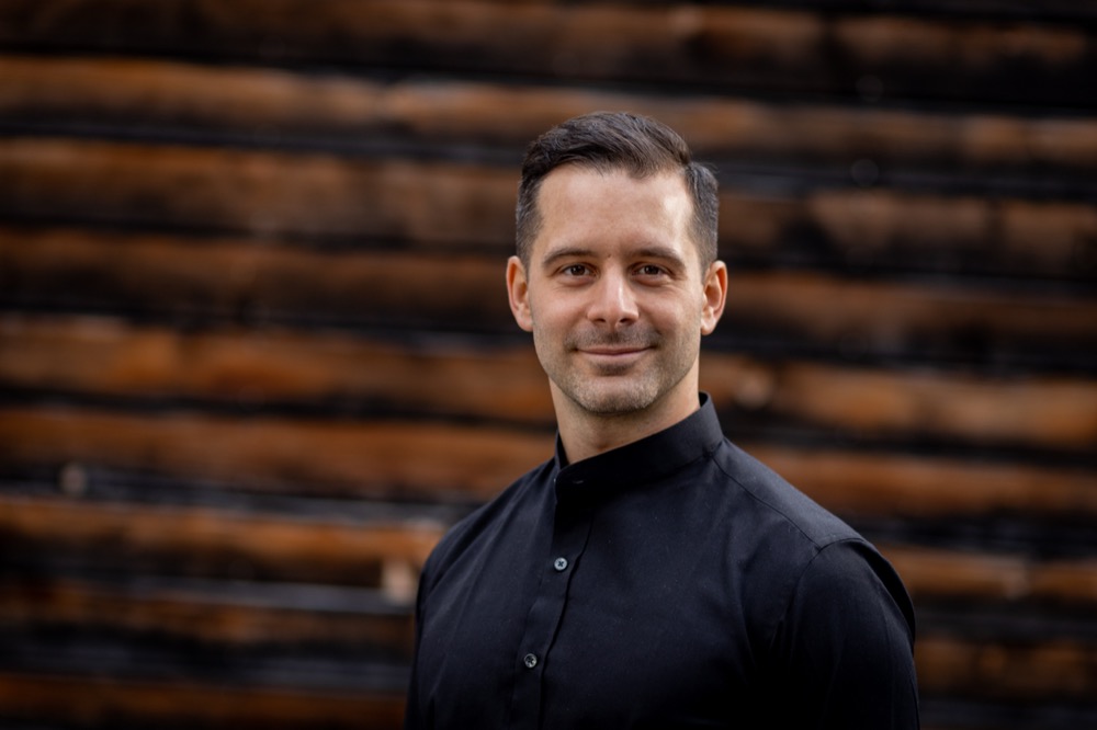 Portrait against a wooden wall, wide