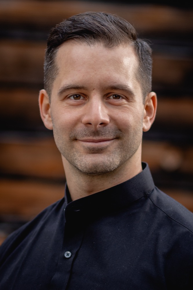 Portrait against a wooden wall, upright